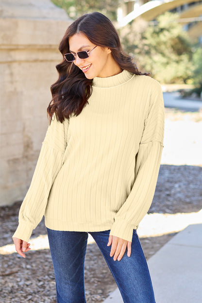 Ribbed knit top has a Mock Neck